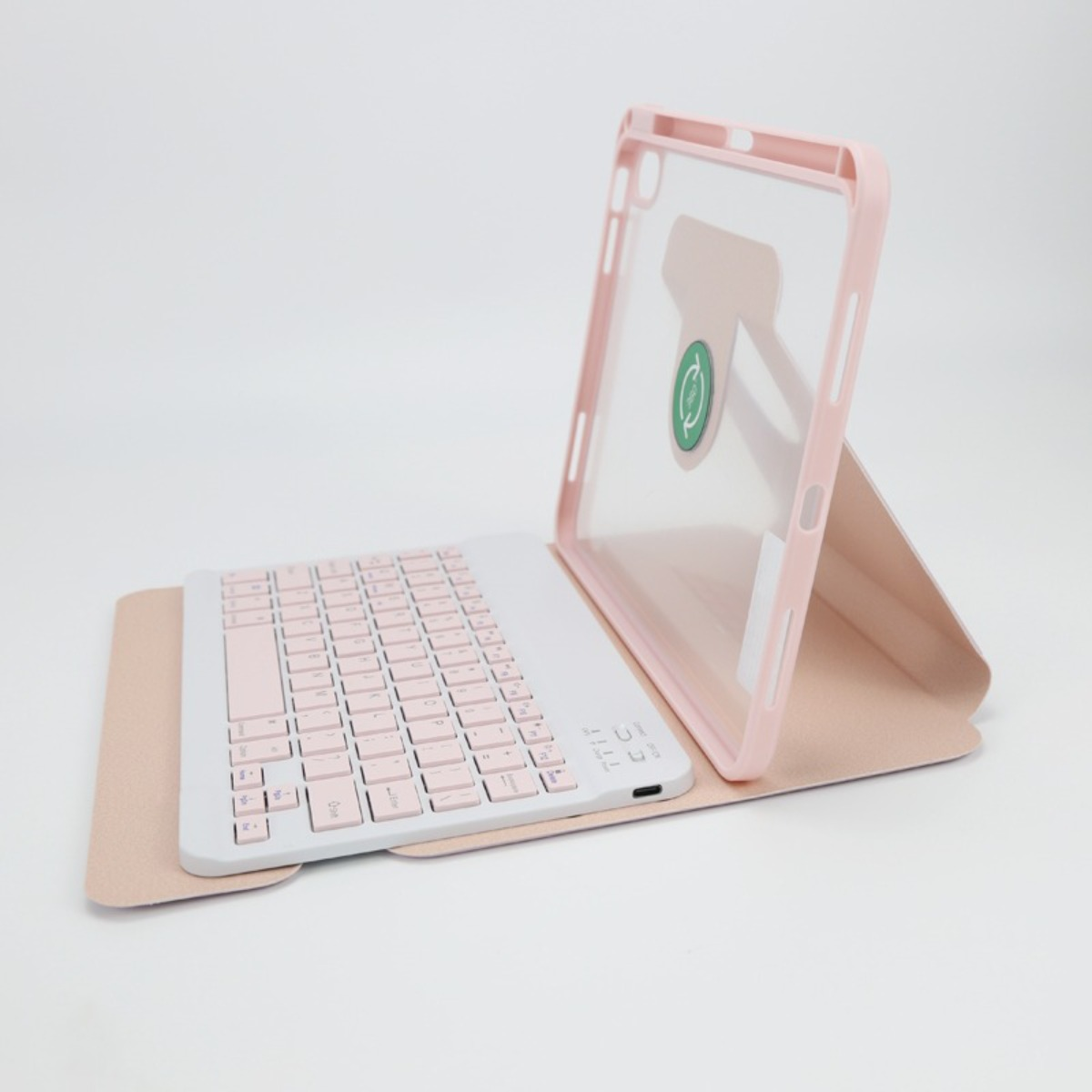 Custodia per tablet rosa con tastiera integrata bianca e rosa su sfondo chiaro.