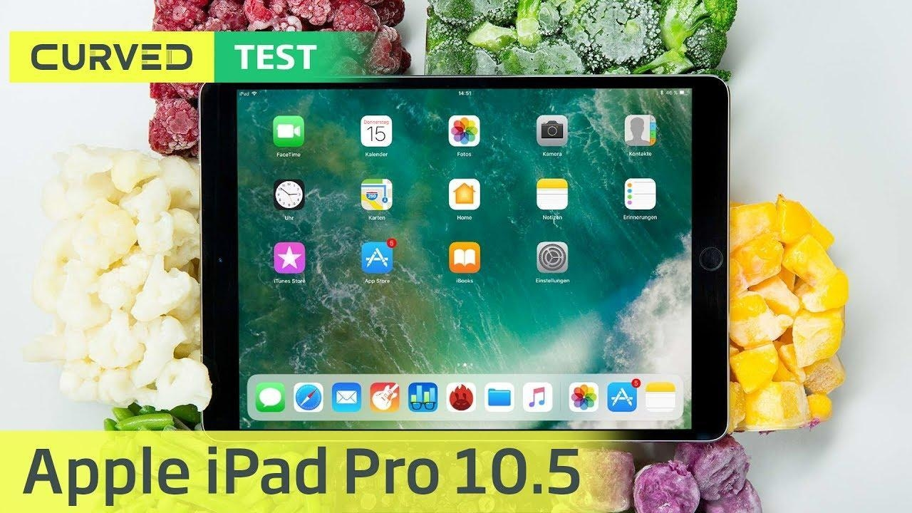 A black Apple iPad Pro 10.5 lies on a light surface, surrounded by colorful frozen food items.