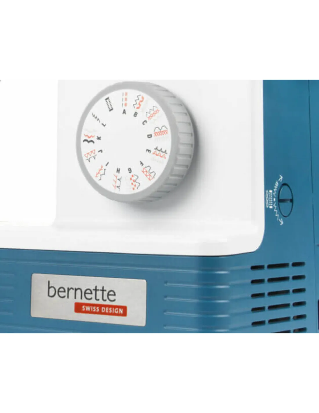 Close-up of a white and blue sewing machine featuring a stitch selection dial and Bernette logo.