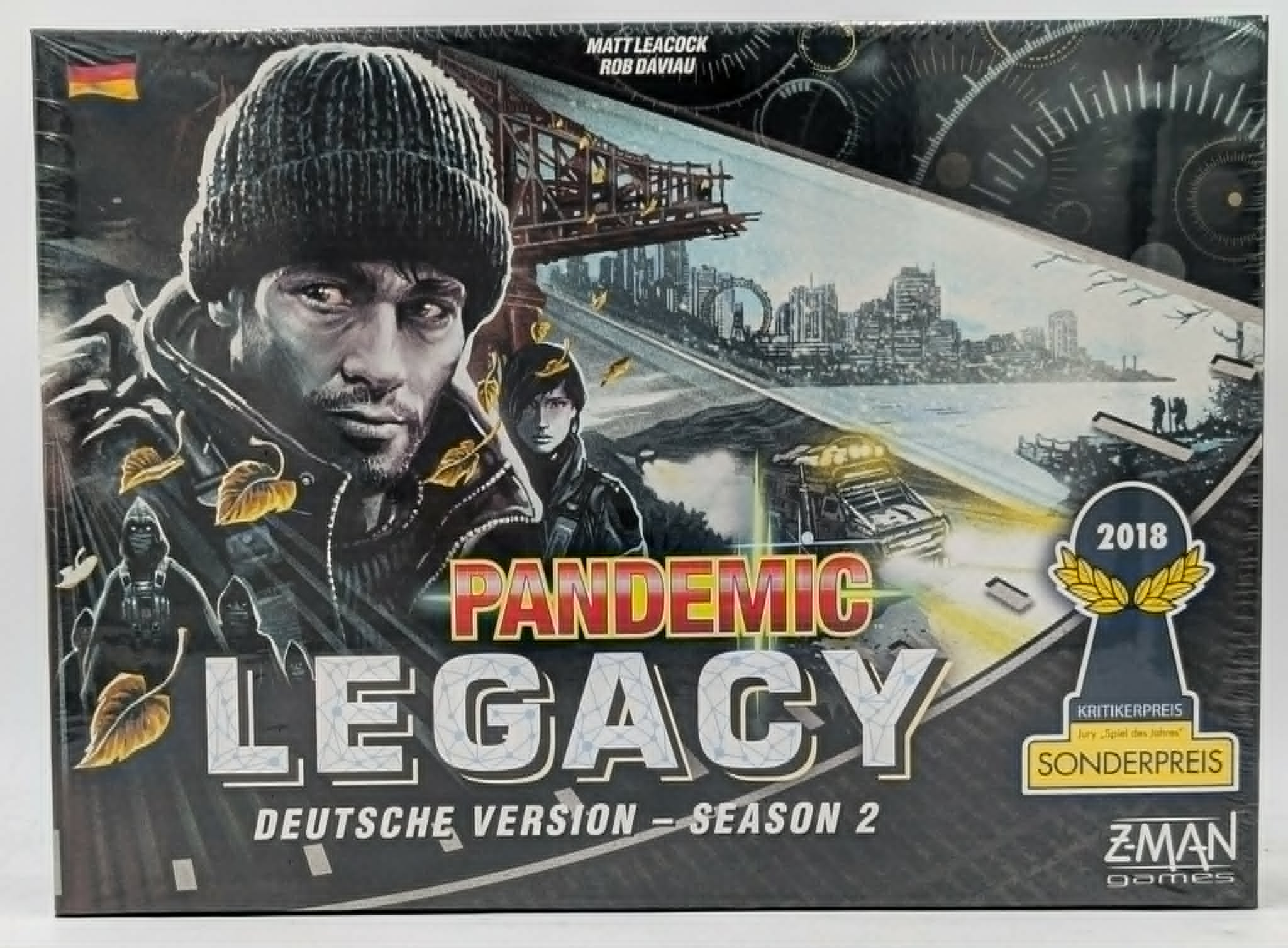 Brettspiel-Box Pandemic Legacy Season 2 mit Illustrationen von Personen, Brücke und einer zerstörten Stadt.