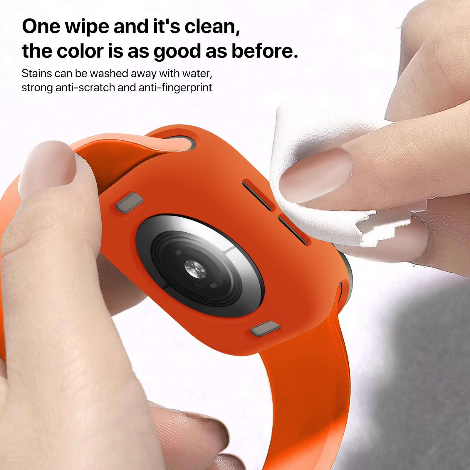 Eine Hand wischt ein oranges Smartwatch-Gehäuse mit einem weißen Tuch ab.