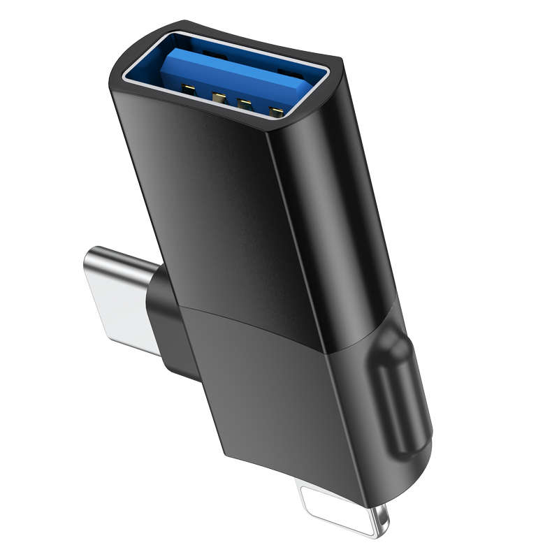 Un adaptador USB negro con un puerto USB azul y dos conectores plateados.