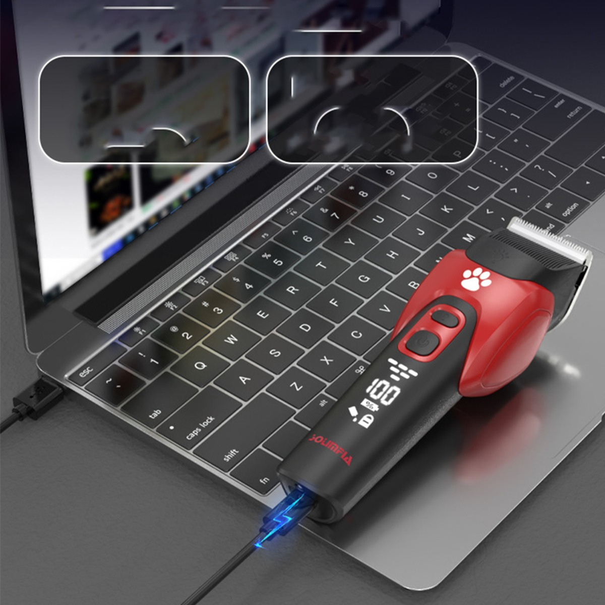 Ein rot-schwarzer Haarschneider für Haustiere mit Digitalanzeige liegt auf einer Laptoptastatur.