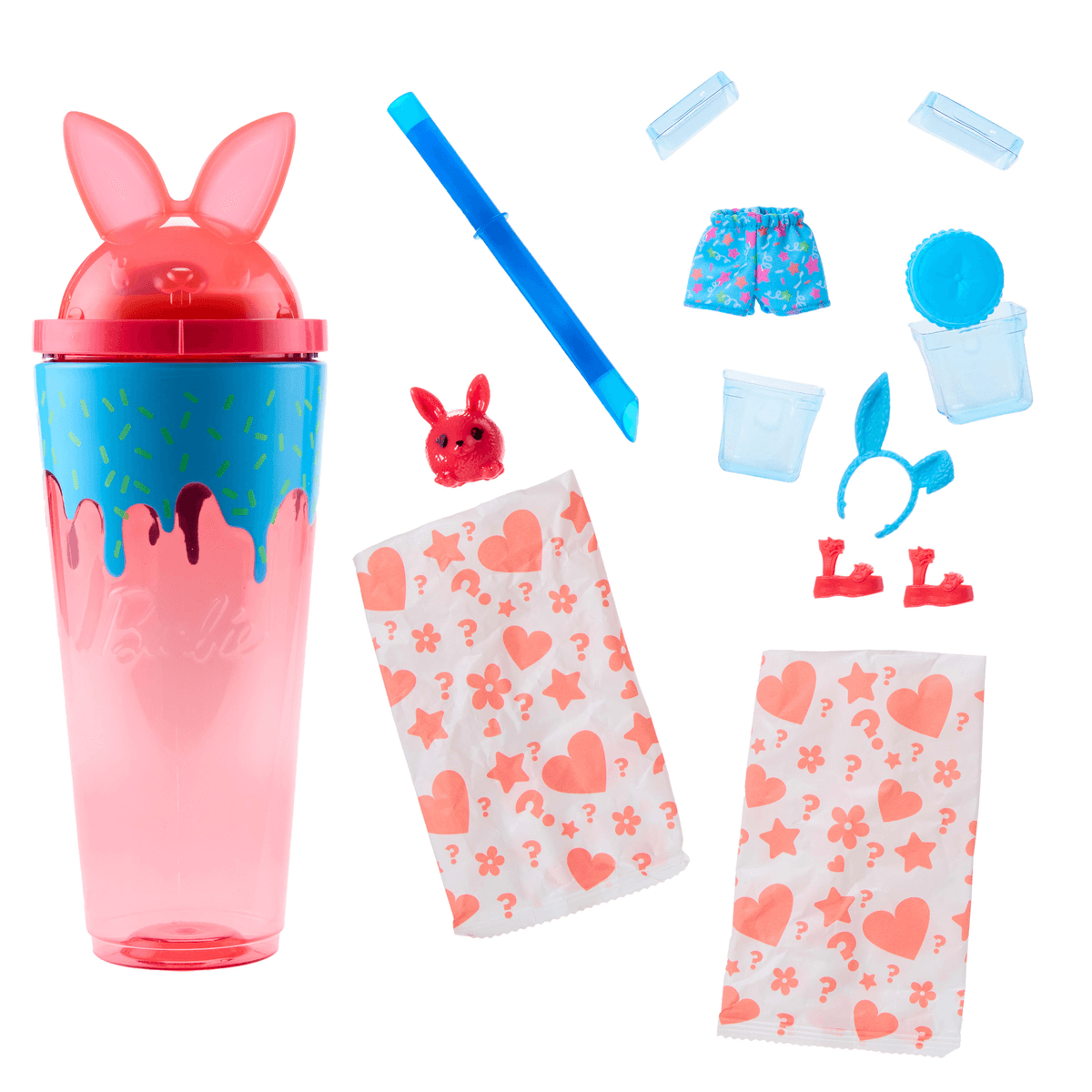 Barbie-Becher mit Hasenohren, bunten Accessoires, Überraschungstüten und einer kleinen roten Tierfigur.