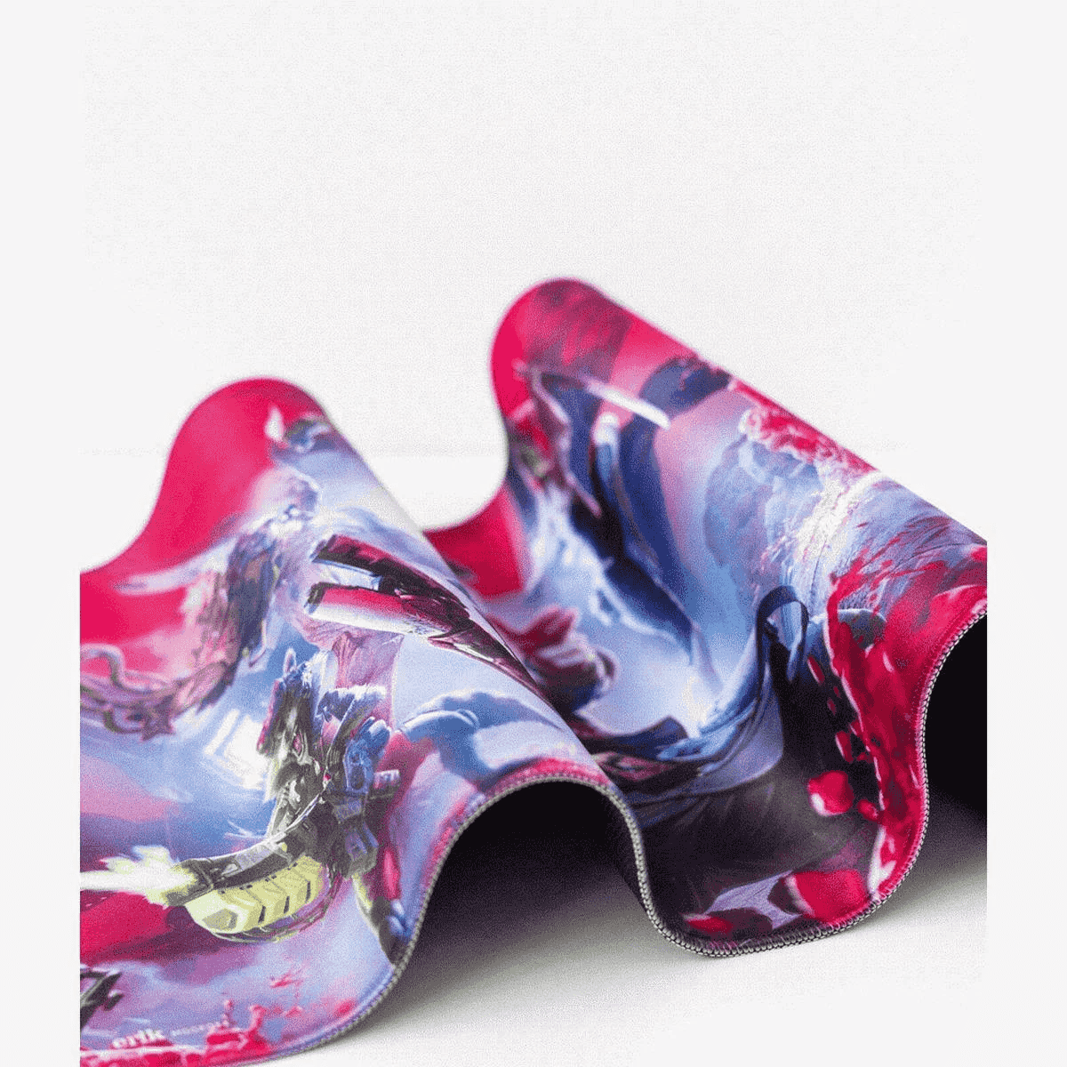 Una estera enrollada con un diseño abstracto vibrante en rosa, azul y blanco sobre un fondo blanco.