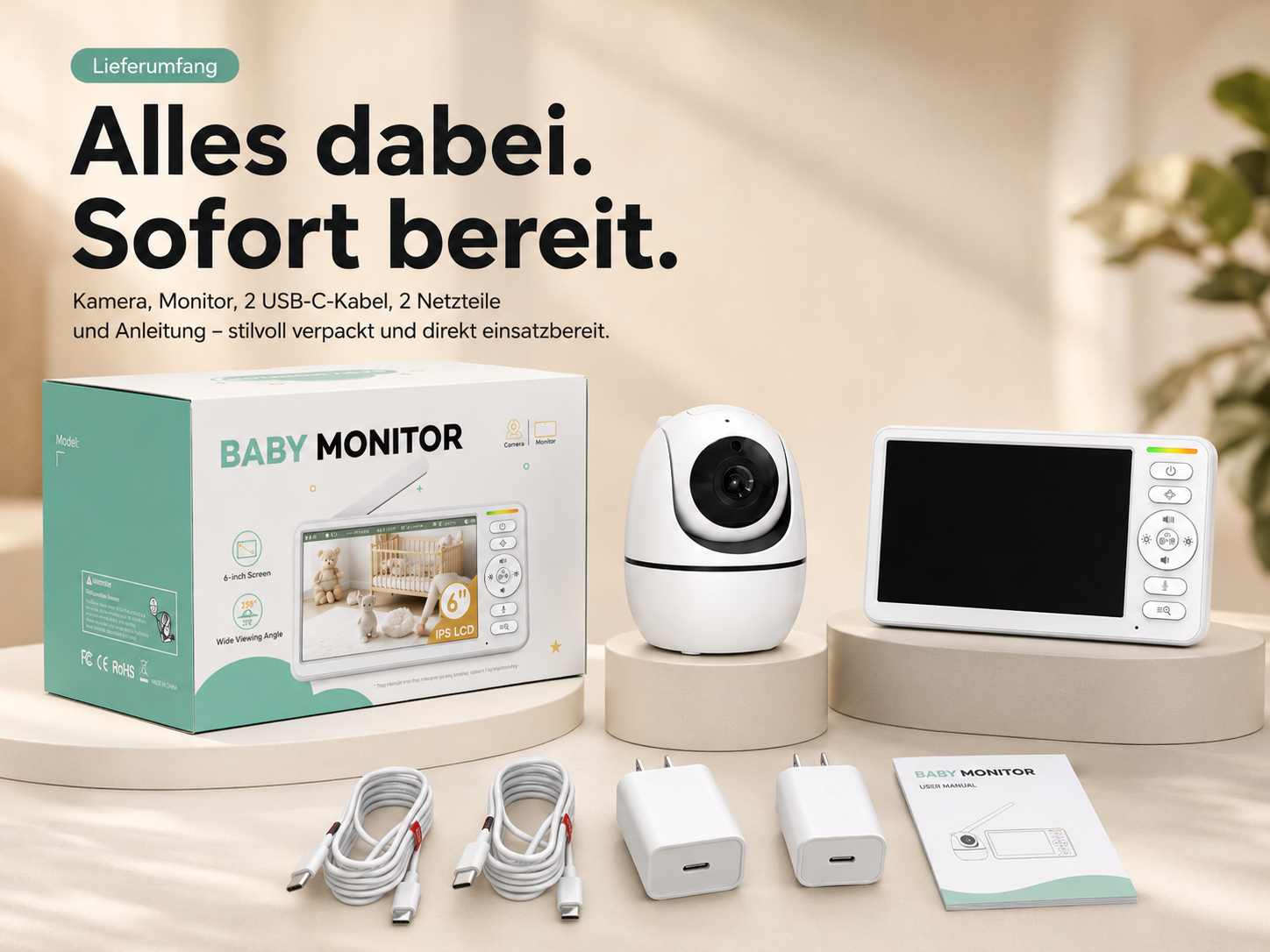 Ein Babyphone-Set mit Kamera, Monitor, zwei Kabeln, zwei Netzteilen und Anleitung auf einem beigen Tisch vor einer Wand.