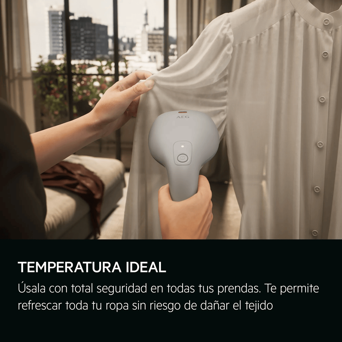 Una persona usa una plancha de vapor gris en una blusa blanca en una habitación luminosa.