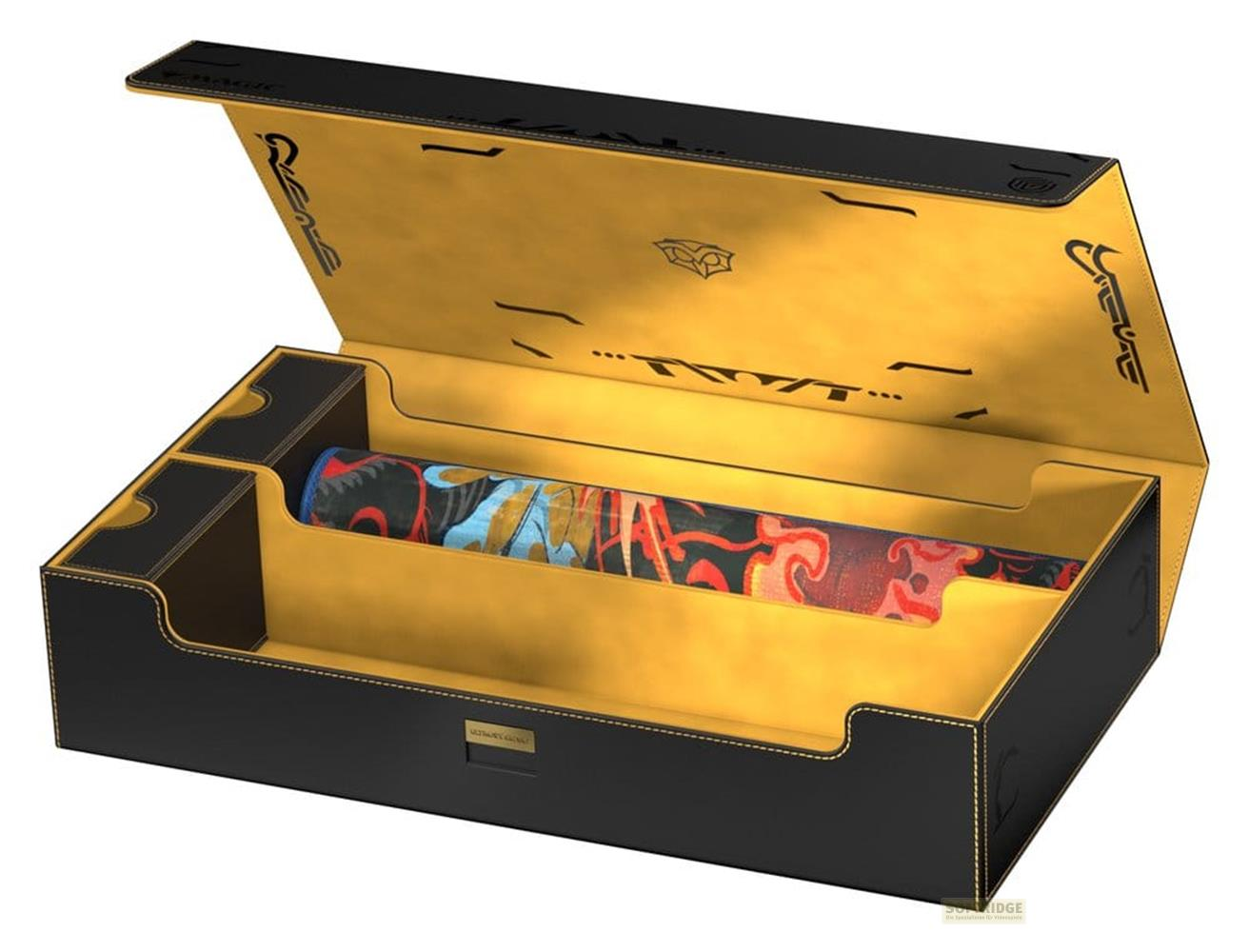 Eine schwarz-goldene Aufbewahrungsbox mit offenem Deckel und einer bunten Rolle im Inneren.