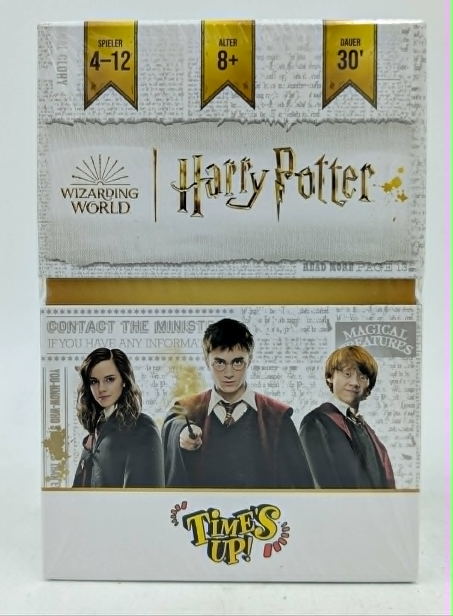 Harry Potter Times Up Brettspiel Schachtel mit Harry, Hermine und Ron vor Zeitungshintergrund.