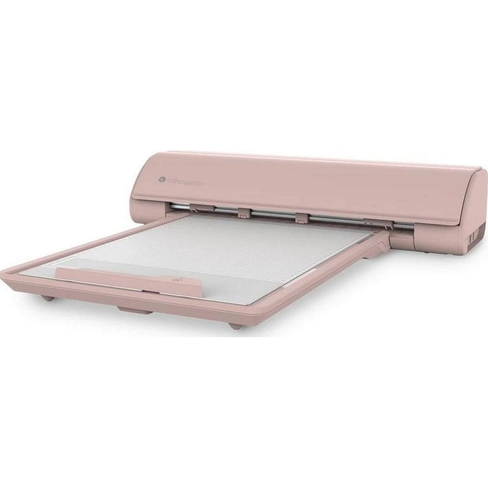 Eine rosa elektronische Schneidemaschine mit einer verlängerten Schneidematte auf weißem Hintergrund.