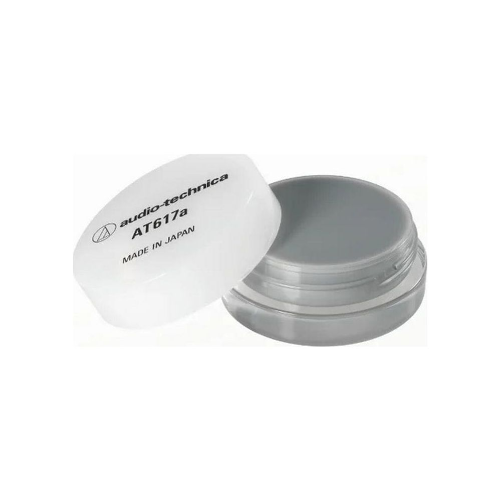 Limpiador de agujas Audio-Technica AT617a en un pequeño recipiente transparente con tapa blanca.