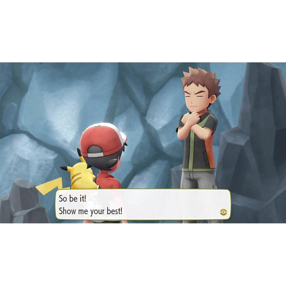 Un allenatore con Pikachu affronta un avversario sicuro in una grotta rocciosa.