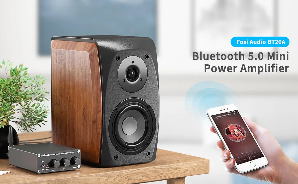 A Fosi Audio mini amplifier, a speaker, and a smartphone on a wooden table.