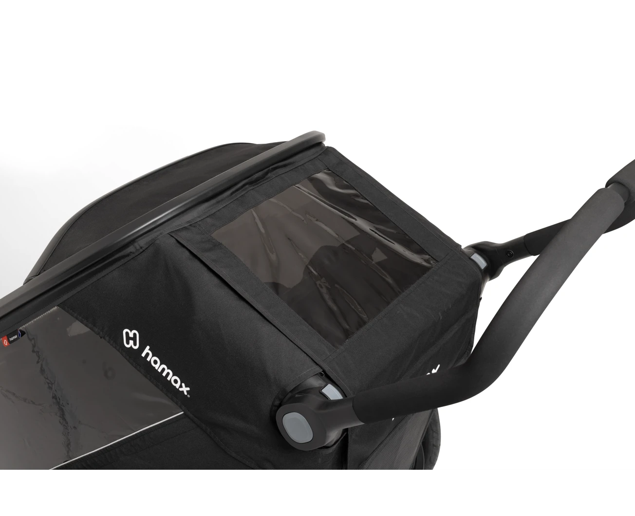 Un remolque de bicicleta Hamax negro con ventana transparente y manillar ajustable sobre fondo blanco.