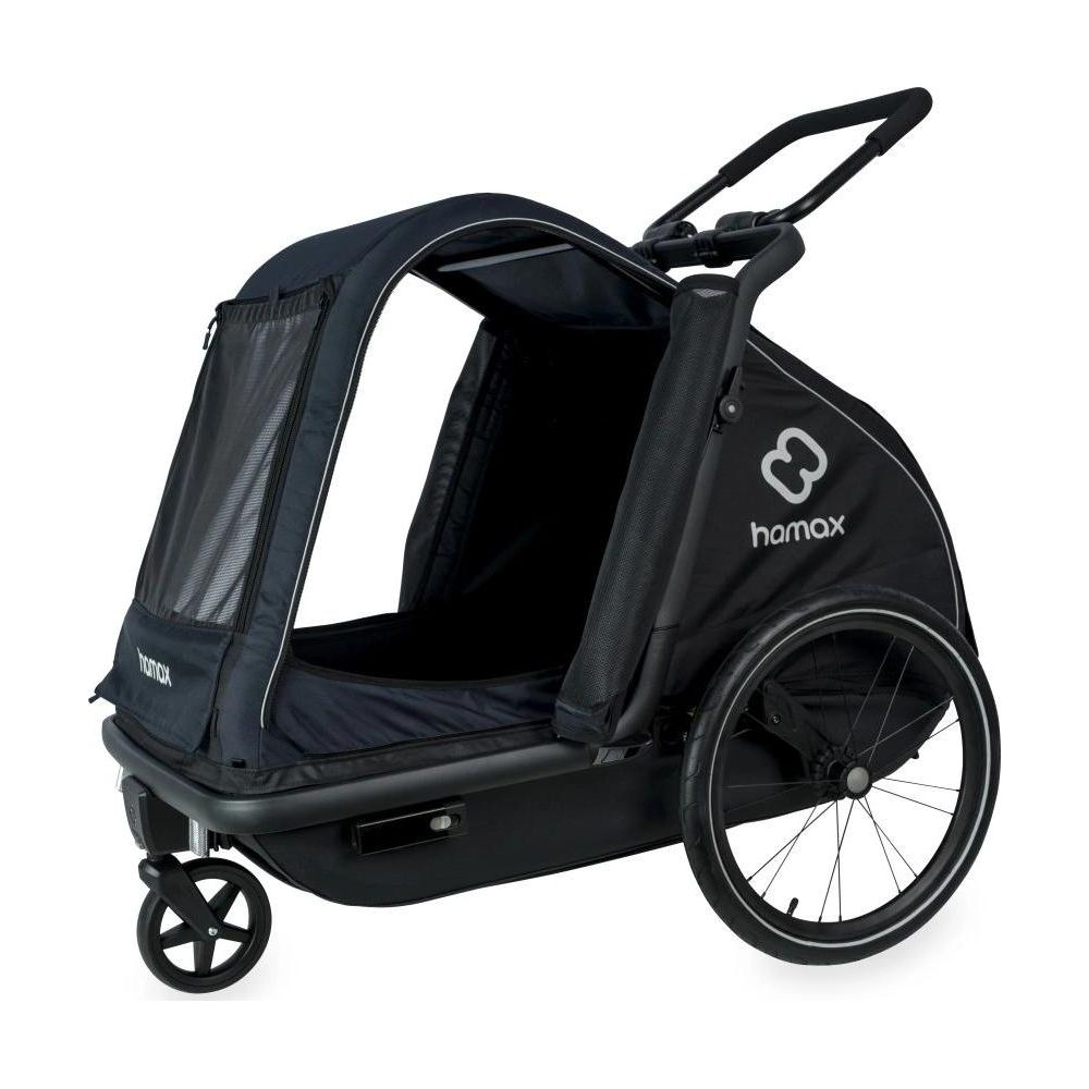 Un remolque de bicicleta Hamax negro con ventanas de malla y tres ruedas sobre fondo blanco.