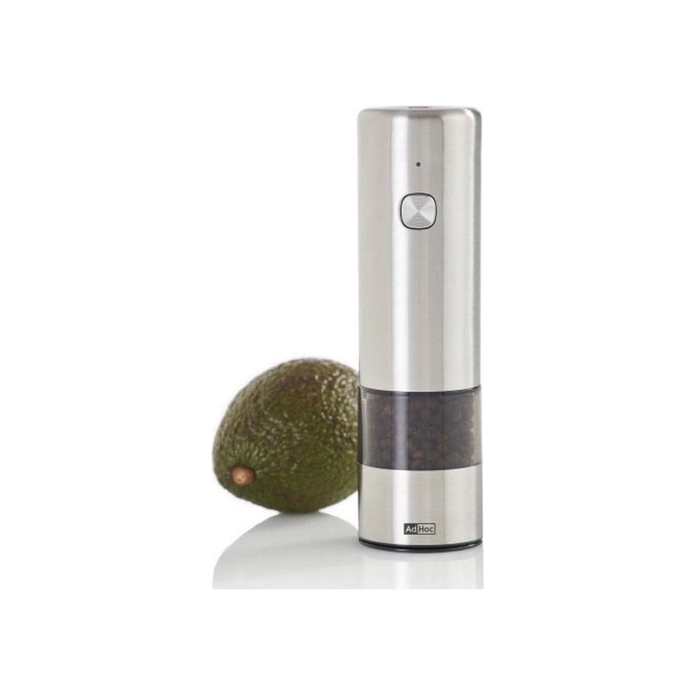 Eine edle Edelstahl-Gewürzmühle mit durchsichtigem Fach steht neben einer frischen Avocado auf weißem Grund.
