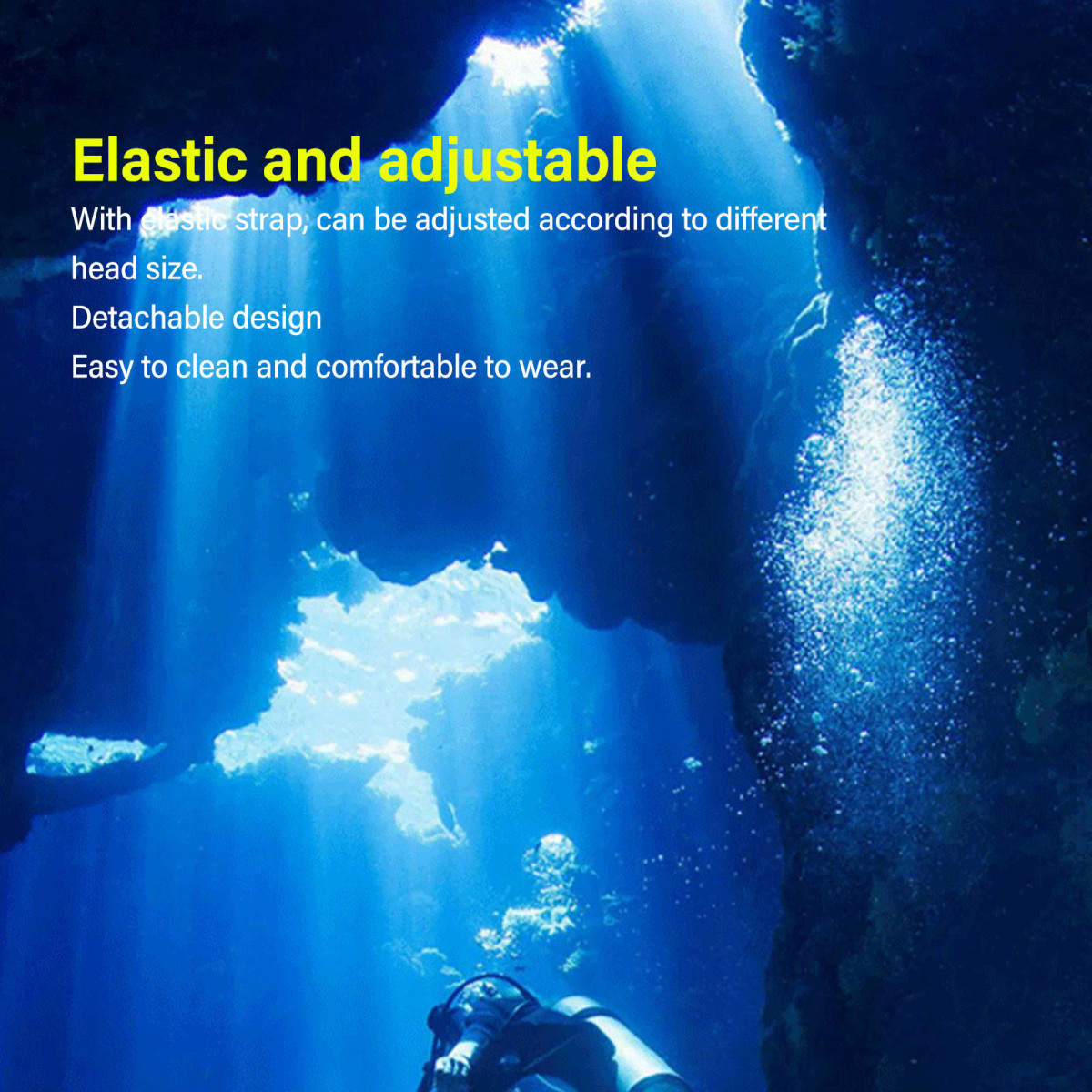 Eine Unterwasserszene mit blauem Wasser, Sonnenlicht von oben, Felsformationen und einem Taucher am Grund.