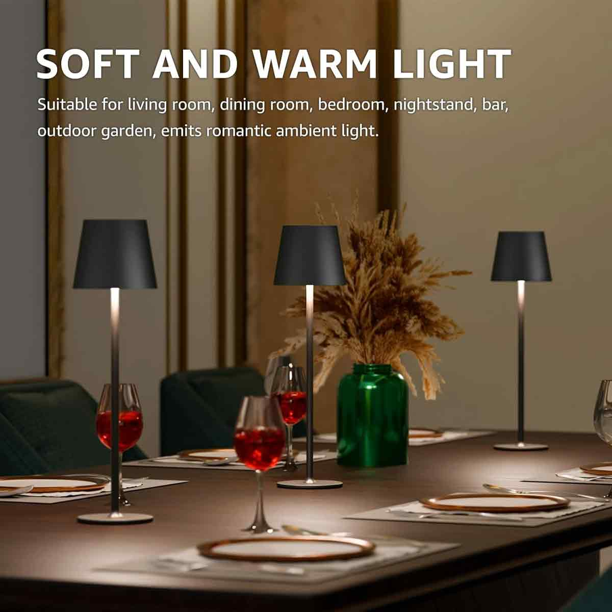 Drei moderne, schlanke Lampen mit schwarzen Schirmen stehen auf einem gedeckten Tisch.