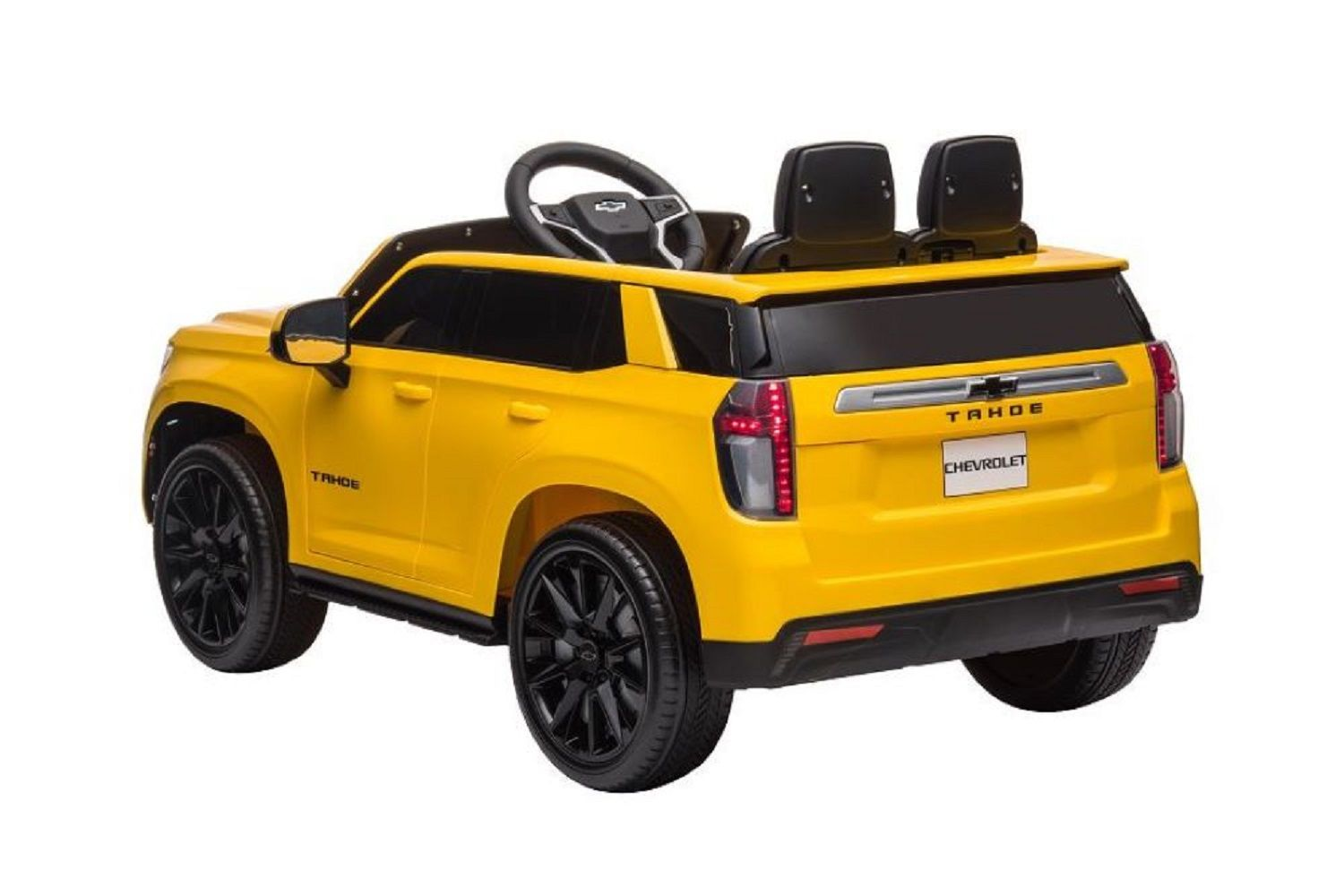 Ein gelbes Spielzeug-Chevrolet Tahoe SUV auf weißem Hintergrund mit schwarzen Rädern und Sitzen sowie einem Lenkrad.