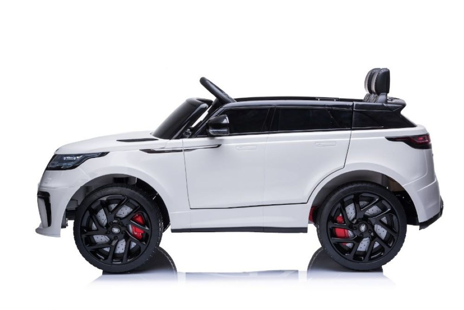Ein weißes Elektroauto für Kinder in Seitenansicht mit schwarzen Felgen und roten Bremssätteln auf weißem Grund.