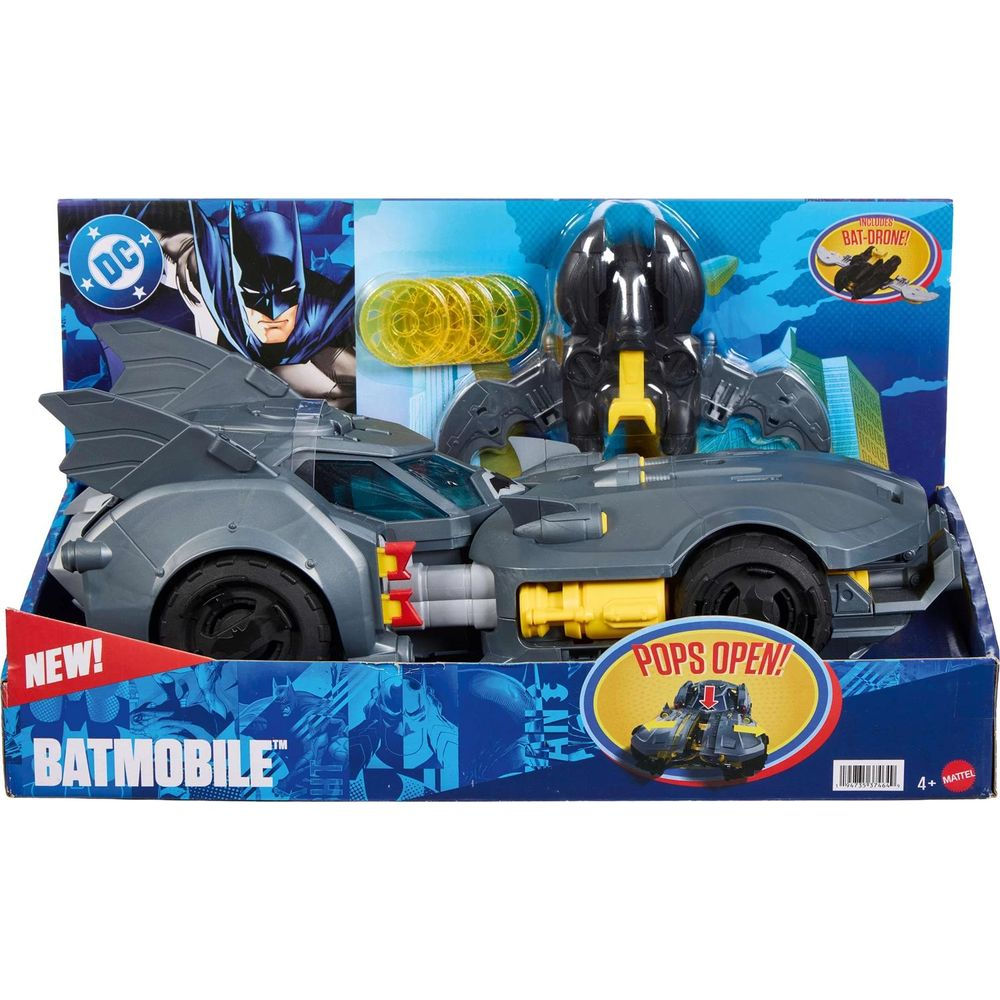 Spielzeug-Batmobil im blauen Karton mit gelben Discs und Drohne.