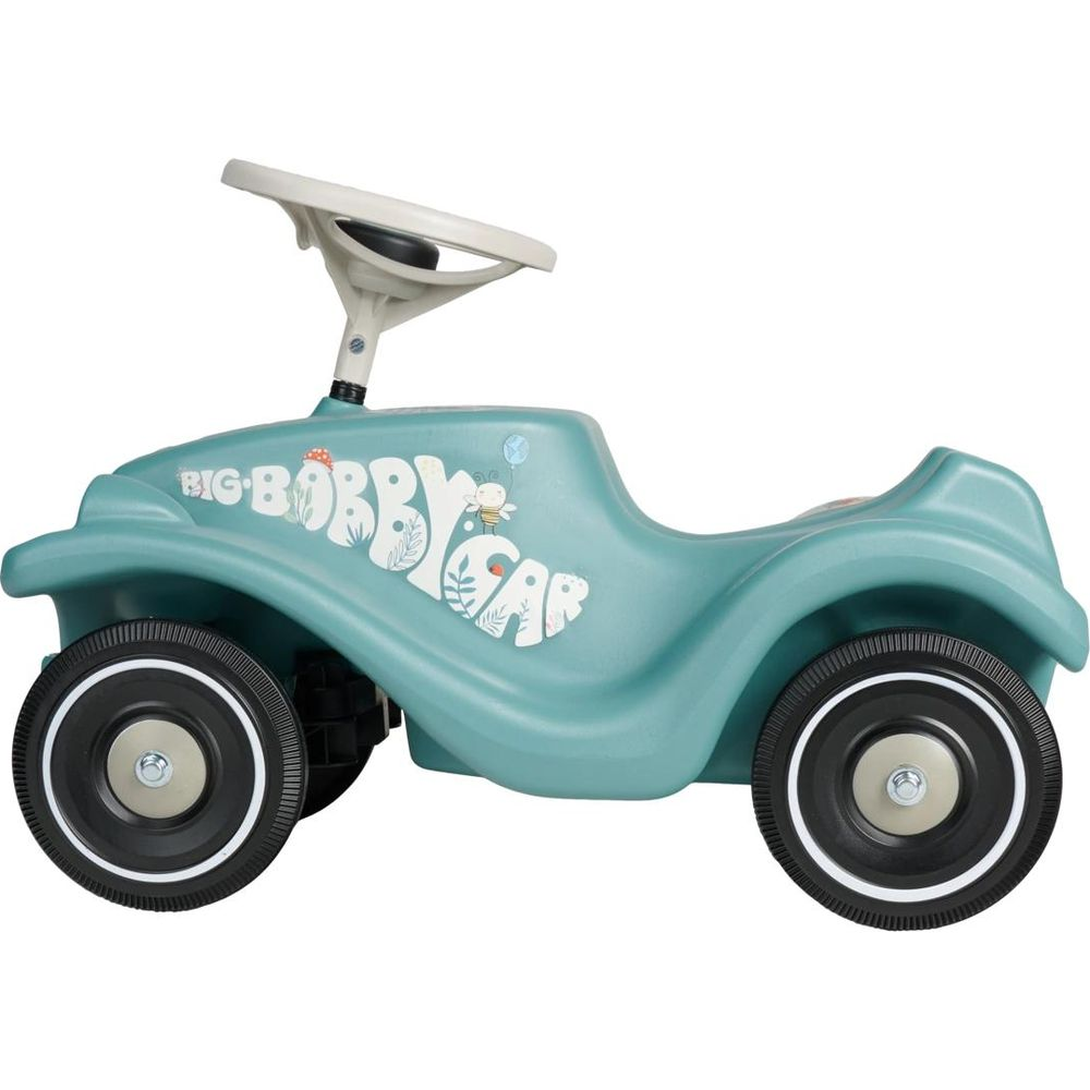Ein türkisfarbenes Bobbycar mit weißem Lenkrad und niedlichen Mustern an der Seite.