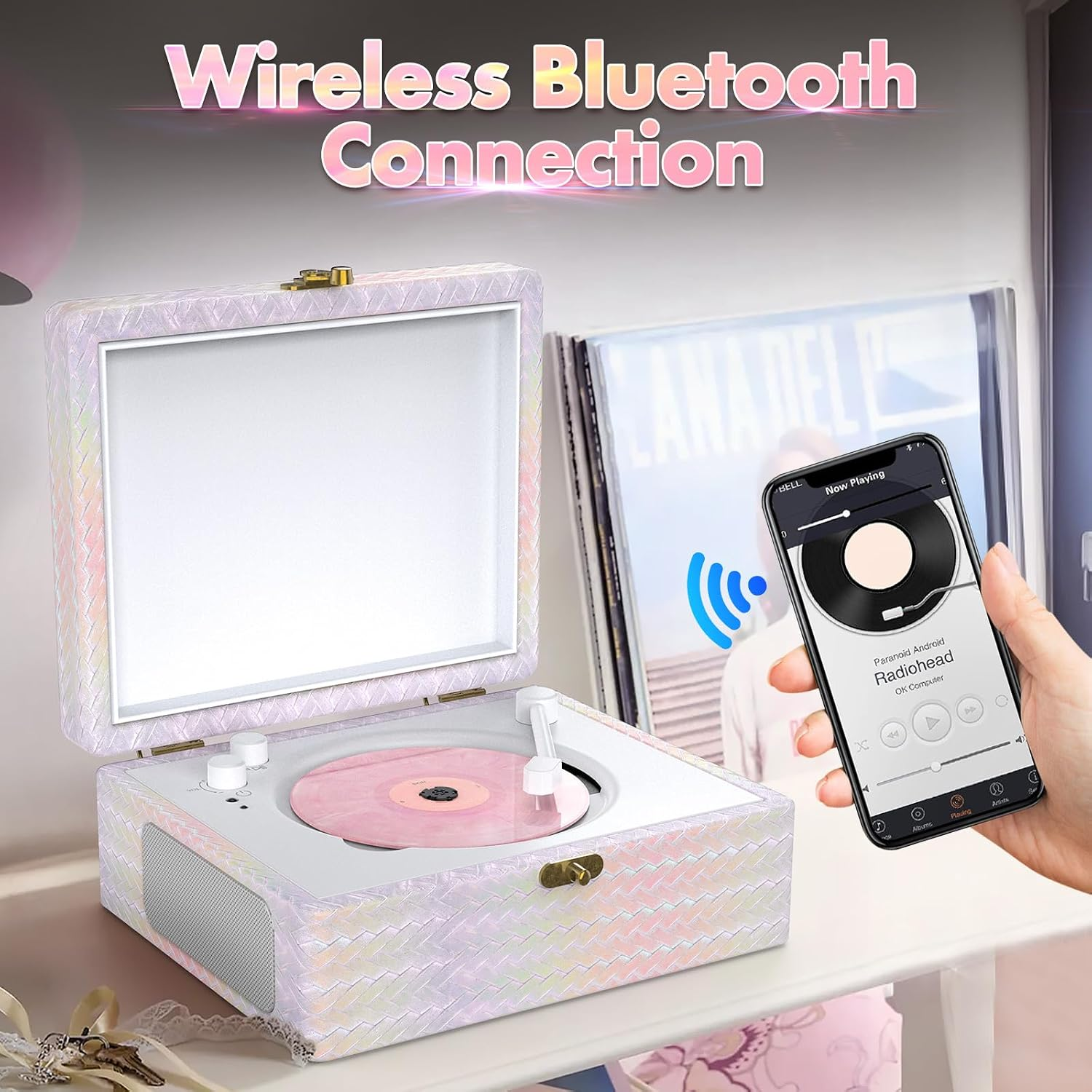 Ein rosa Schallplattenspieler, der über Bluetooth mit einem Smartphone verbunden ist.