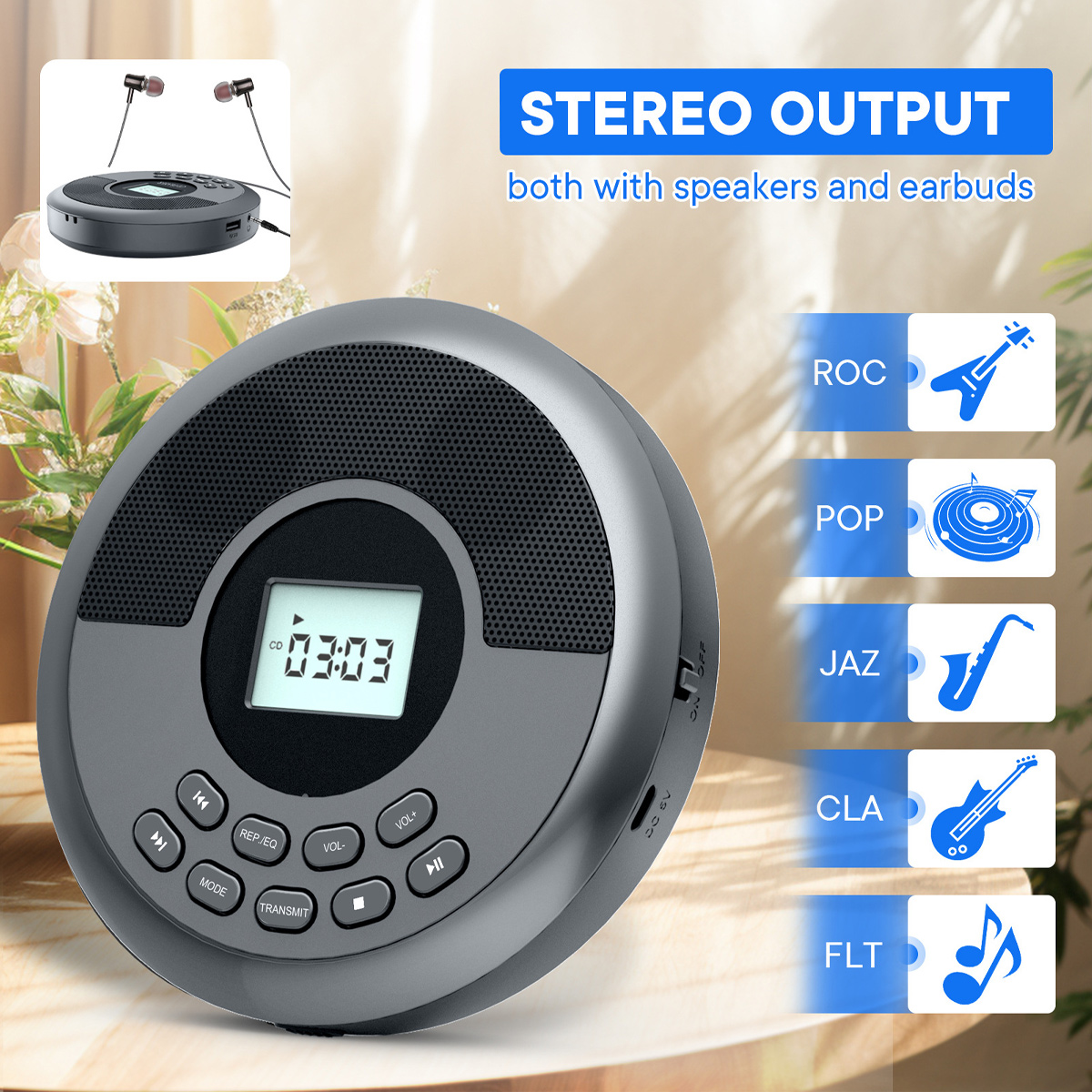 Grauer CD-Player mit eingebauten Lautsprechern, Digitaldisplay und Tasten auf einem Holztisch.