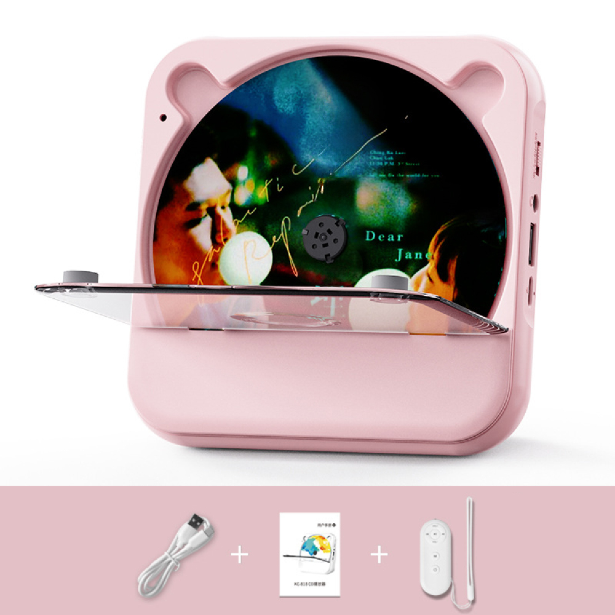 Ein rosafarbener CD-Player mit transparenter Klappe und CD, darunter Ladekabel, Anleitung und Fernbedienung.