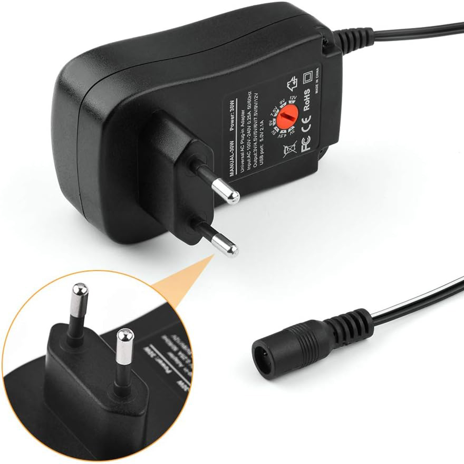 Ein schwarzer Universal-Netzadapter mit einem runden Spannungswahlschalter, Steckern und Kabel.