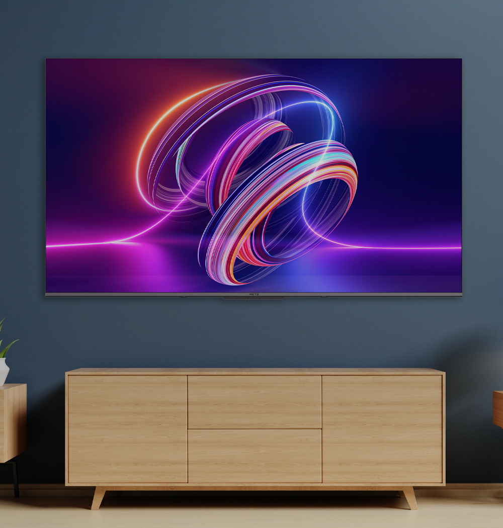 Una grande TV mostra cerchi di luce colorati sopra un mobile in legno moderno contro una parete blu.