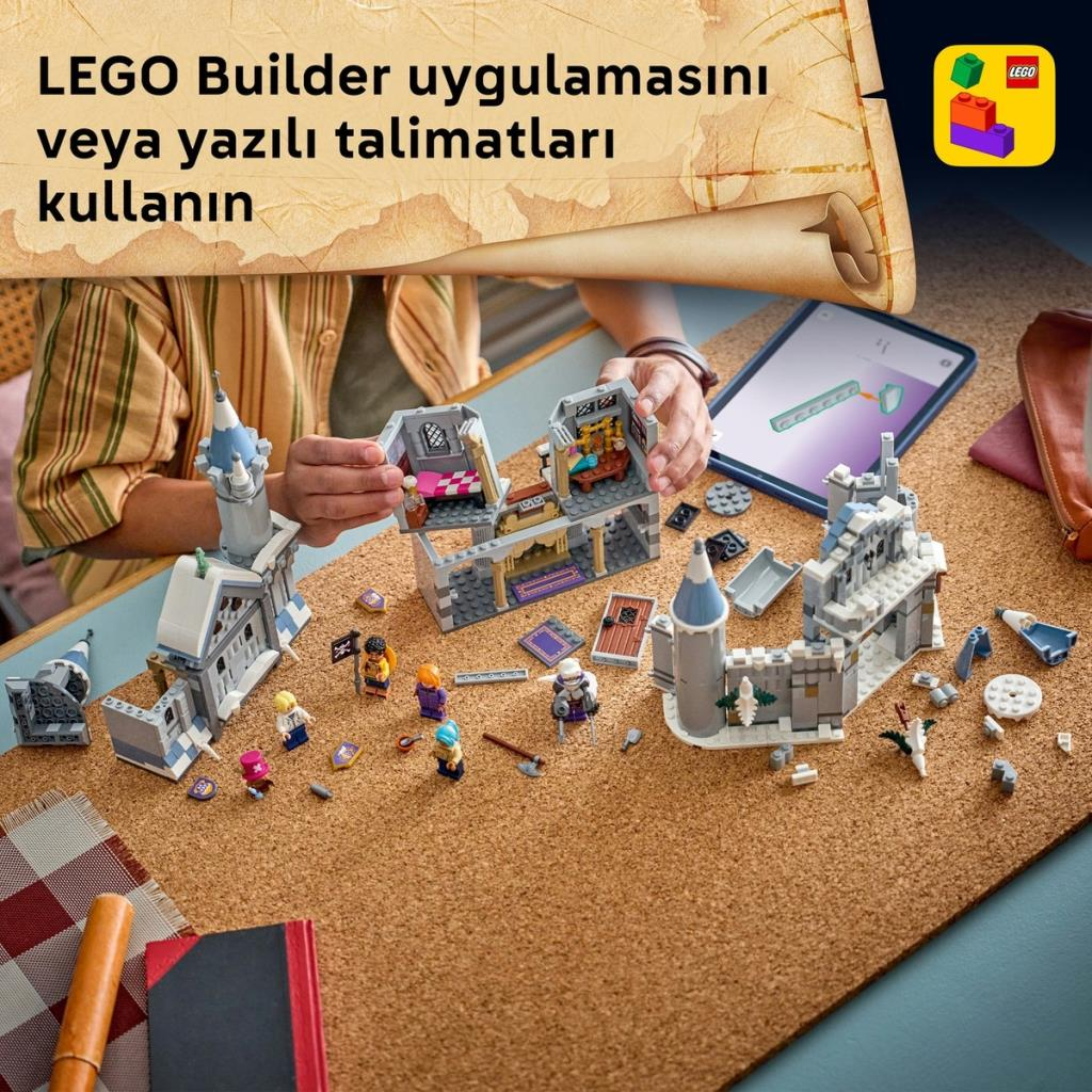 Un niño construye un castillo de LEGO en una mesa con instrucciones digitales en una tableta.
