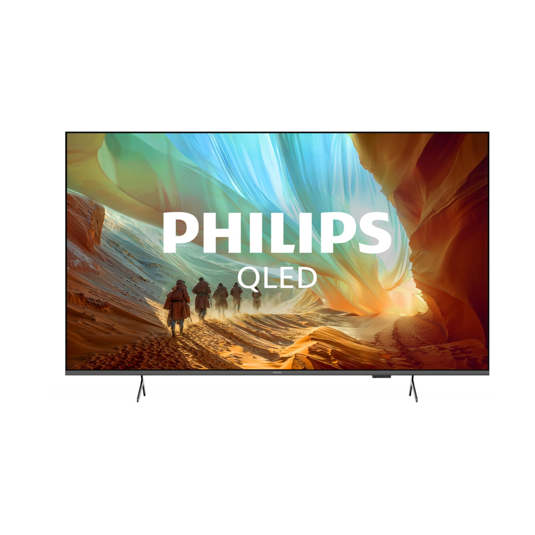 Un televisor Philips QLED muestra un paisaje colorido con figuras caminando en primer plano.