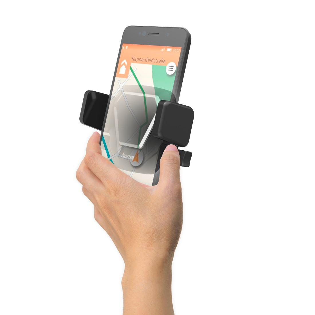 Ręka trzyma smartfon w czarnym uchwycie z mapą nawigacyjną na białym tle.