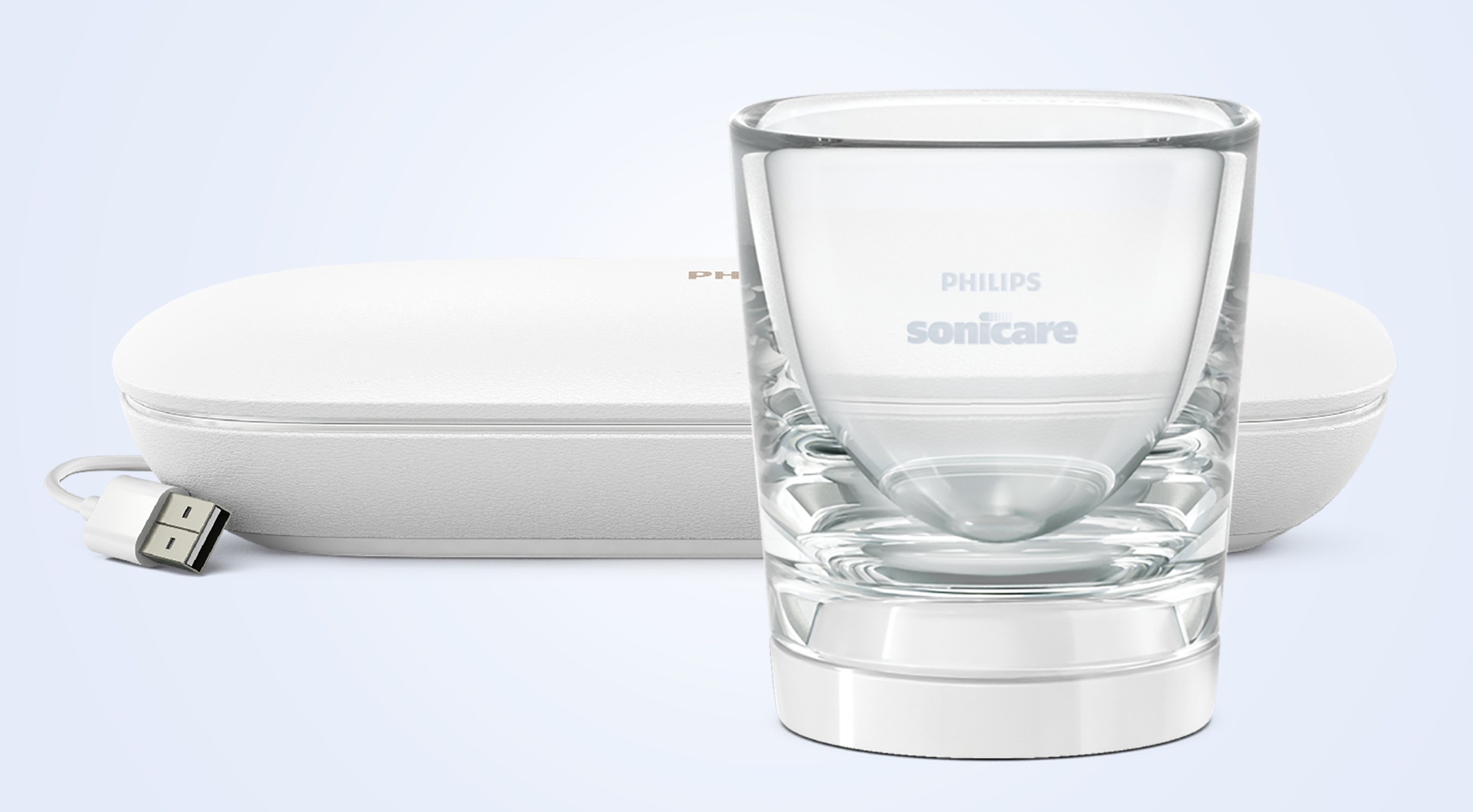 Un bicchiere con marchio Philips Sonicare si trova davanti a una custodia di ricarica bianca e cavo USB su sfondo azzurro.