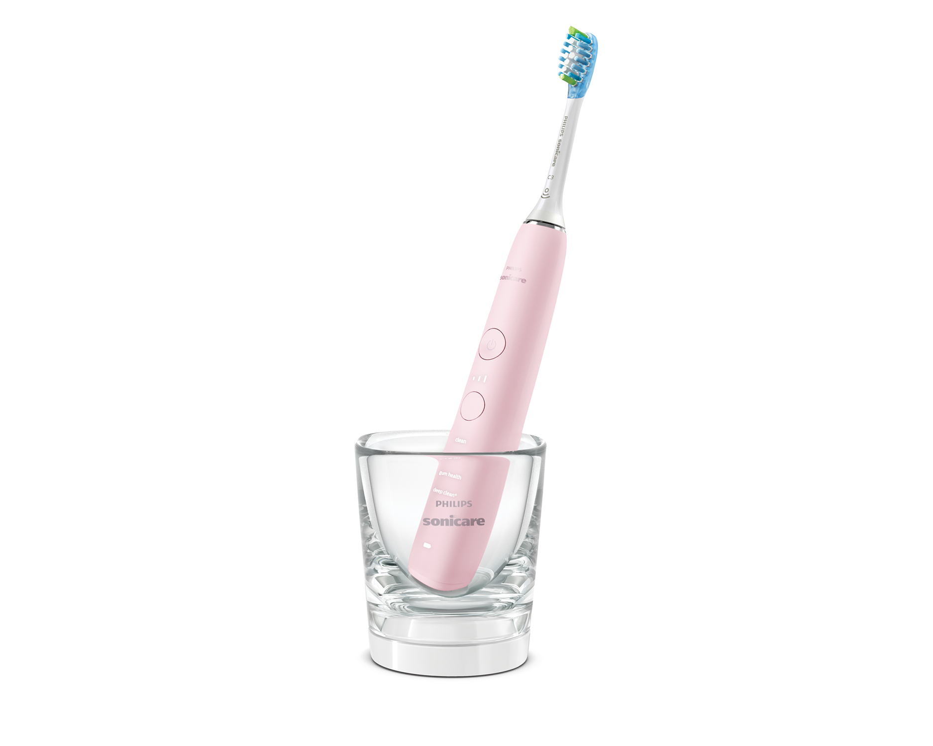 Uno spazzolino elettrico rosa Philips Sonicare in un bicchiere di vetro trasparente su sfondo bianco.