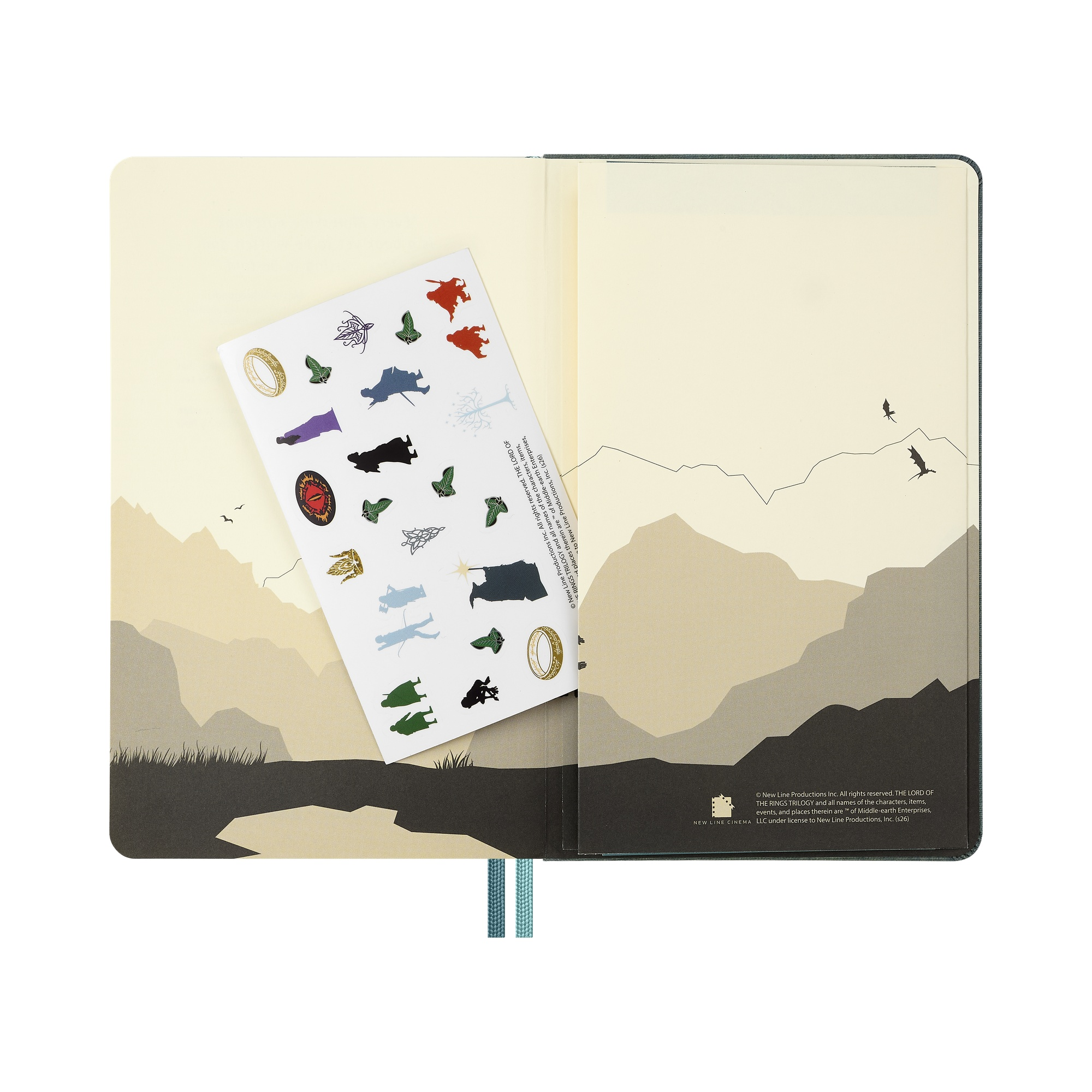 Ein Notizbuch mit Herr der Ringe Stickern und Berglandschaft.