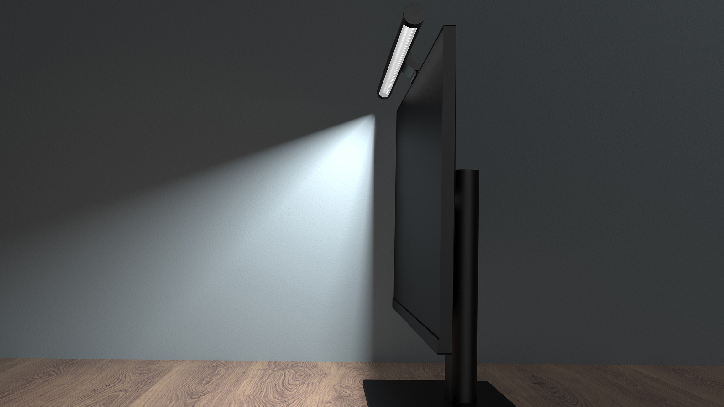 Eine Monitorlampe oben auf einem Computermonitor leuchtet weißes Licht an eine dunkle Wand.
