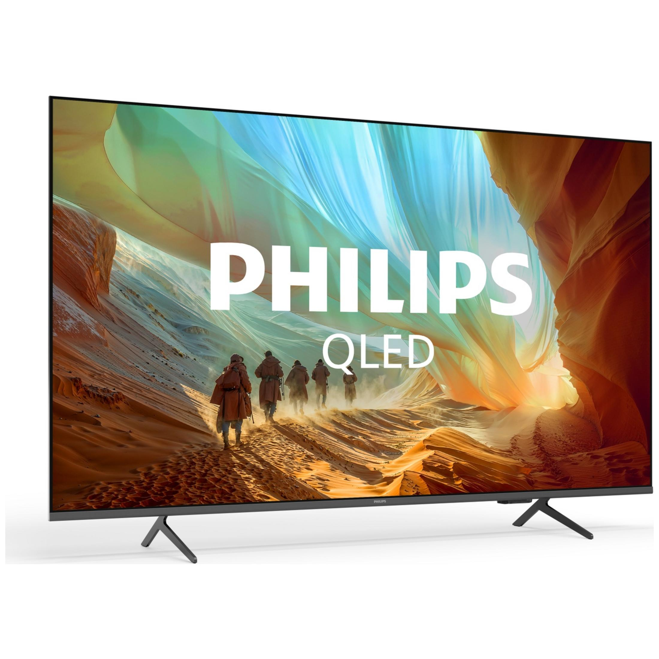 Un televisor Philips QLED muestra un paisaje colorido con figuras caminando por un sendero.