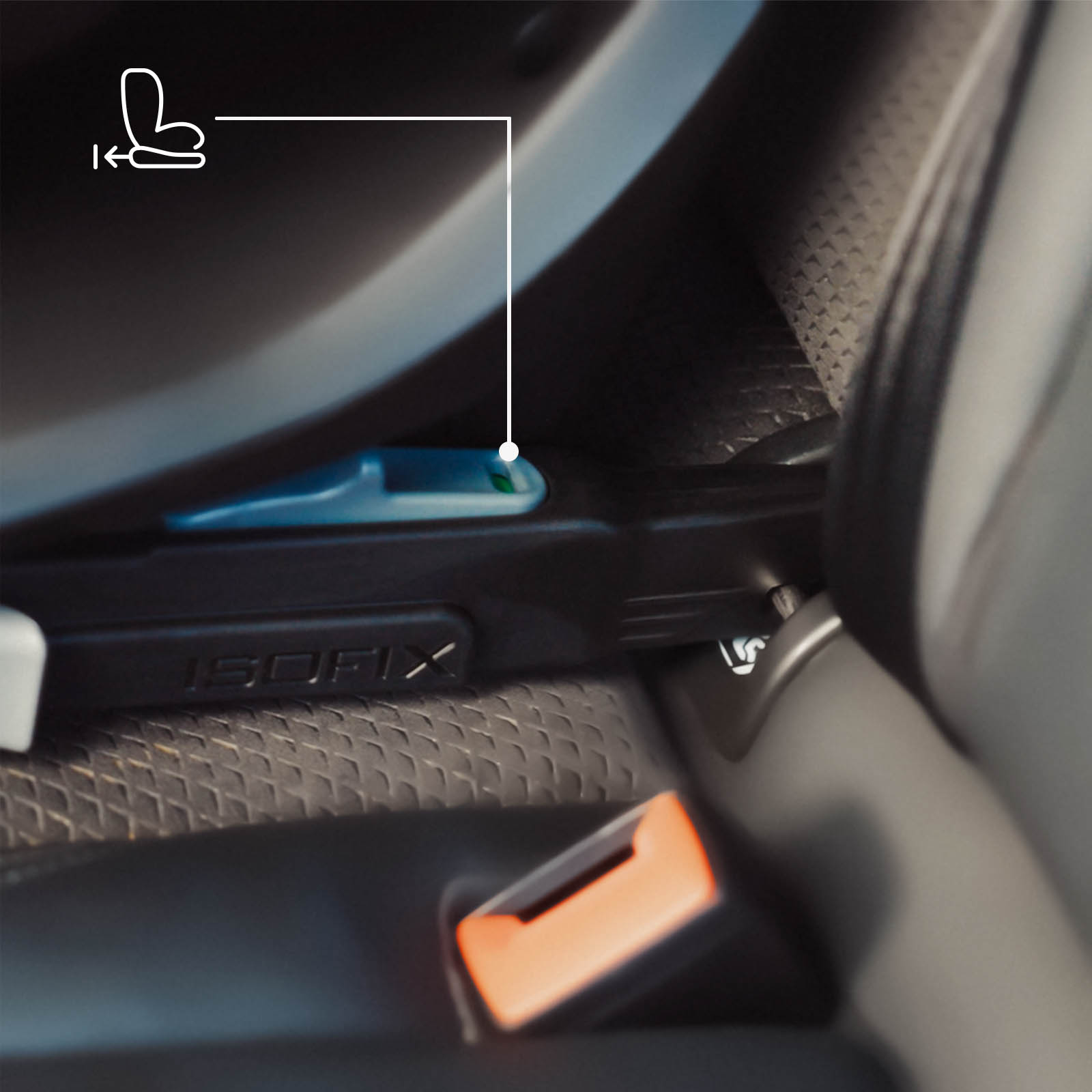 Nahaufnahme einer ISOFIX-Kindersitzverankerung mit grünem Indikator in einem Auto.