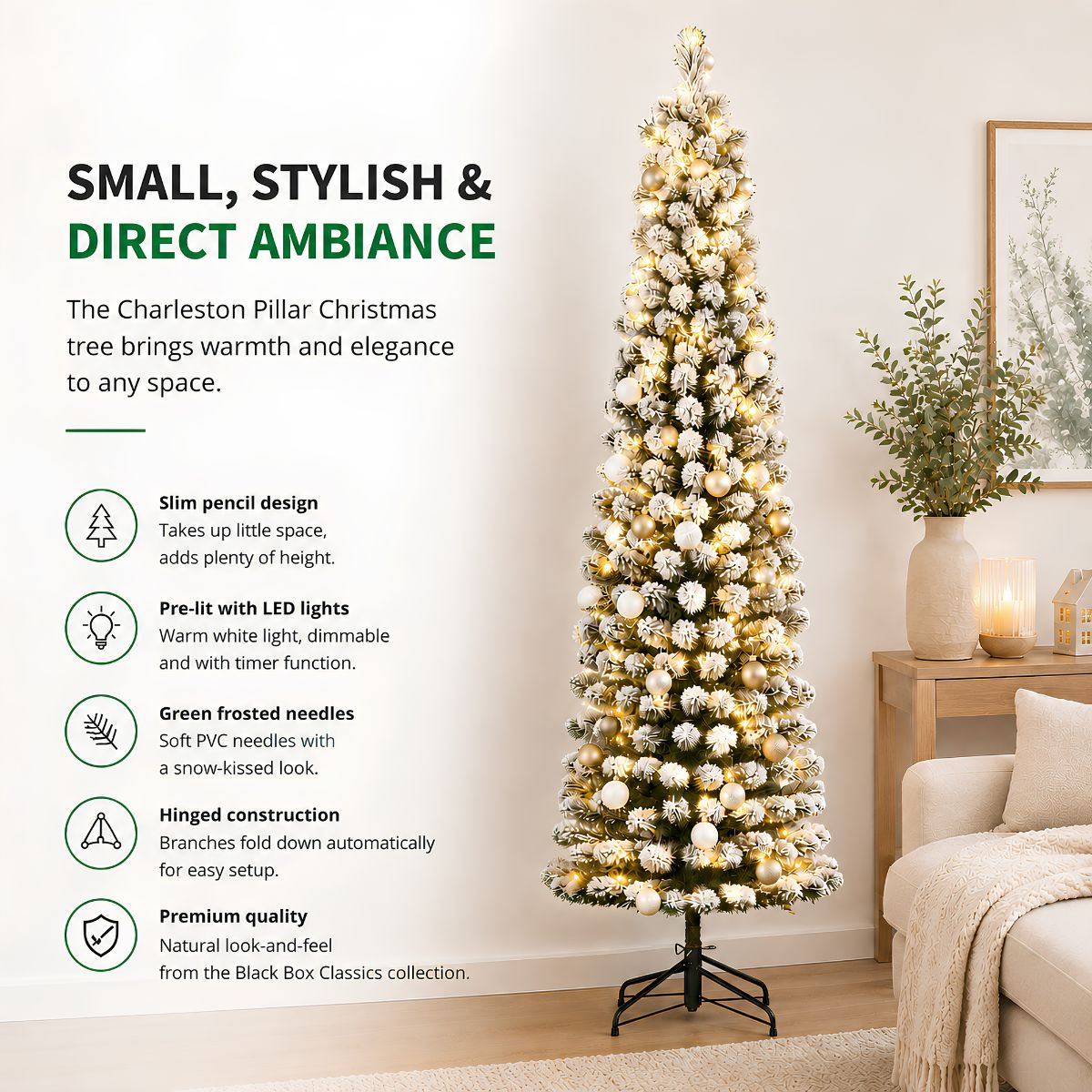A slim artificial Christmas tree with LED lights stands in a living room beside a white couch.