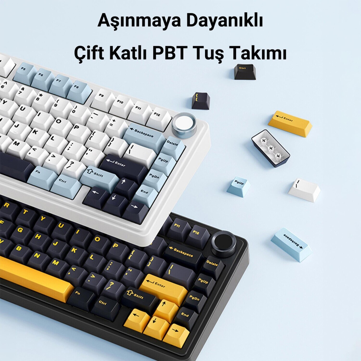Açık mavi arka planda mavi, beyaz, siyah ve sarı tuşlara sahip iki mekanik klavye.