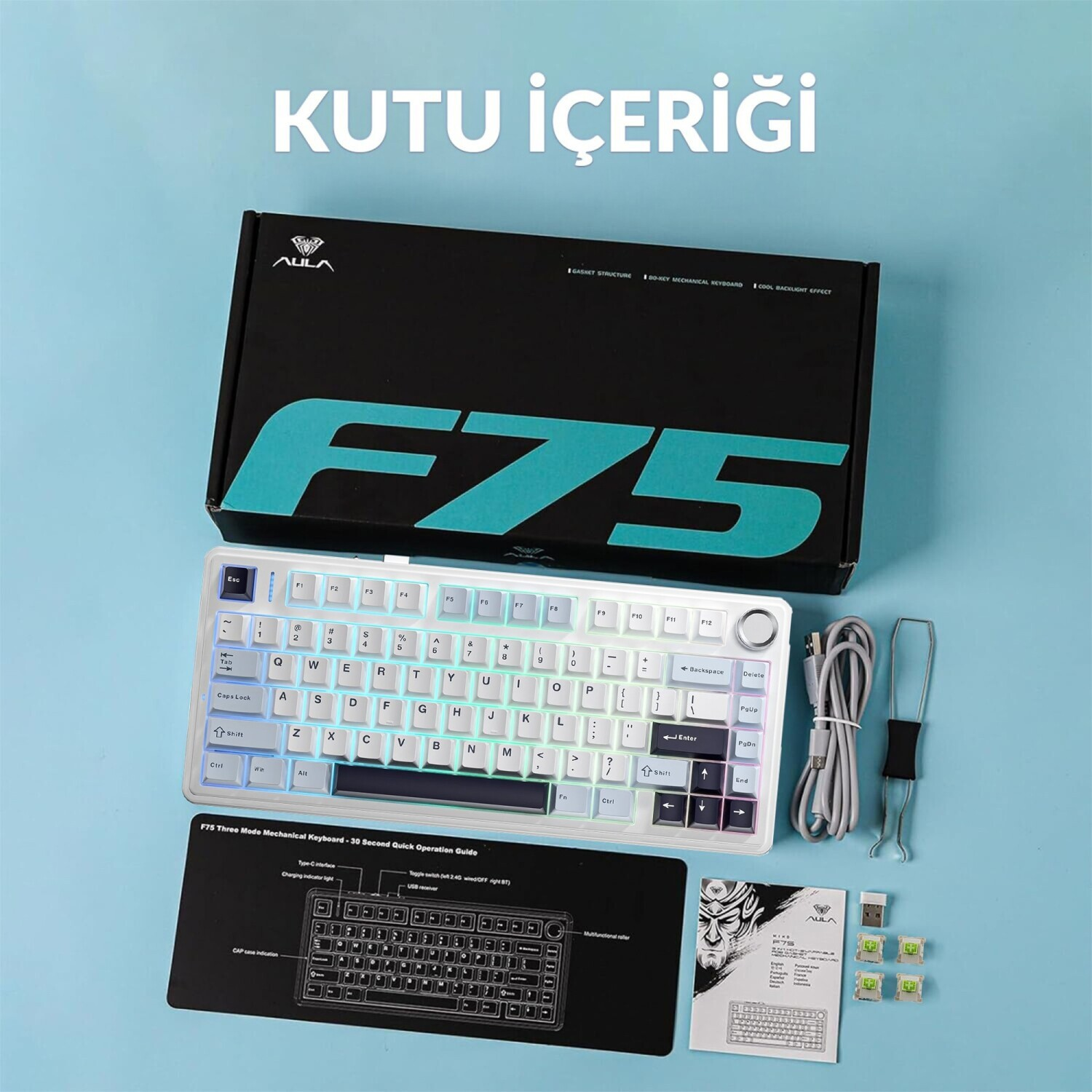 Mavi zemin üzerinde kutusu, kablosu, kılavuzu ve aksesuarlarıyla AULA F75 klavye kutu içeriği.