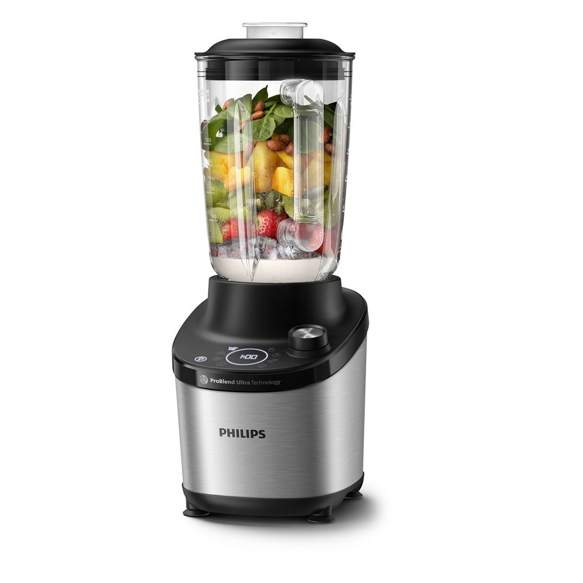 Una licuadora Philips plateada llena de frutas, espinacas y frutos secos sobre fondo blanco.