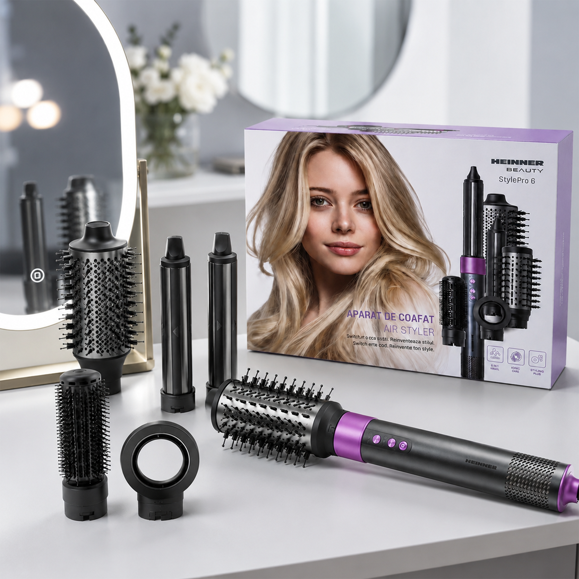 Heinner StylePro 6 Air Styler mit verschiedenen Aufsätzen auf einem Tisch vor einer Produktverpackung und einem Spiegel.