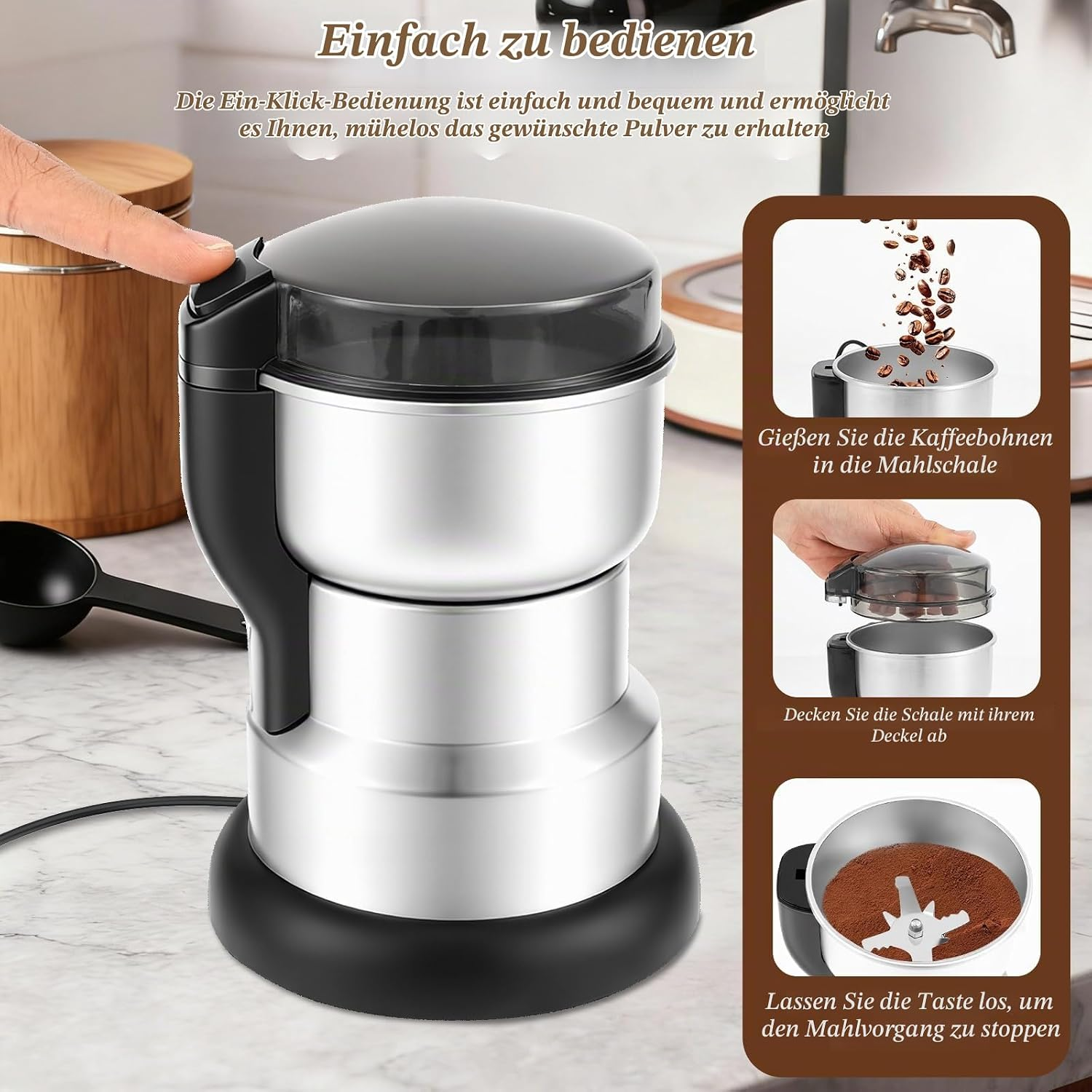Eine silberne Kaffeemühle mit schwarzem Sockel steht auf einer Marmorarbeitsplatte, daneben Anleitungstafeln.