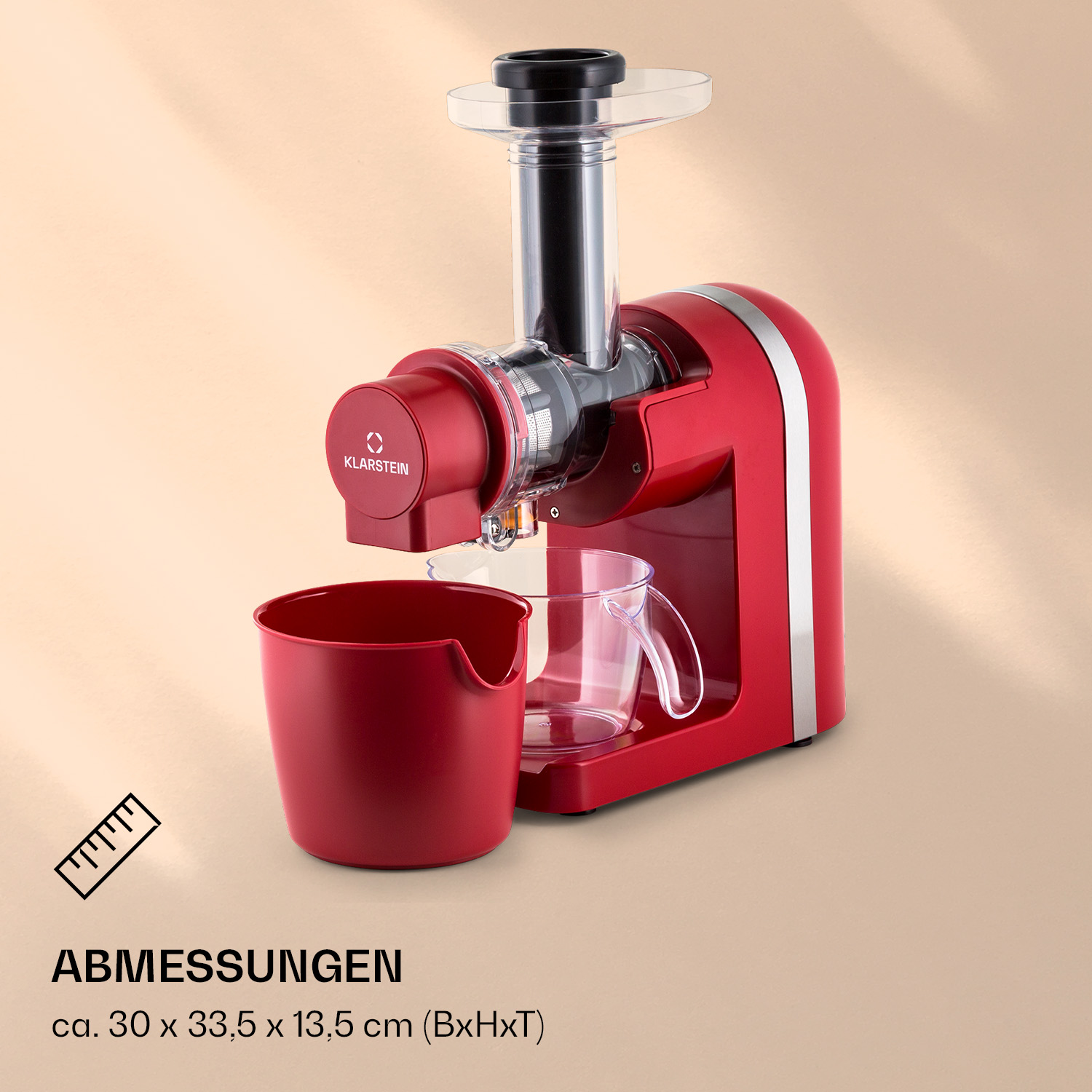 Ein roter Klarstein Slow Juicer mit klarem Einfüllschacht, rotem Tresterbehälter und Glas auf beigem Grund.