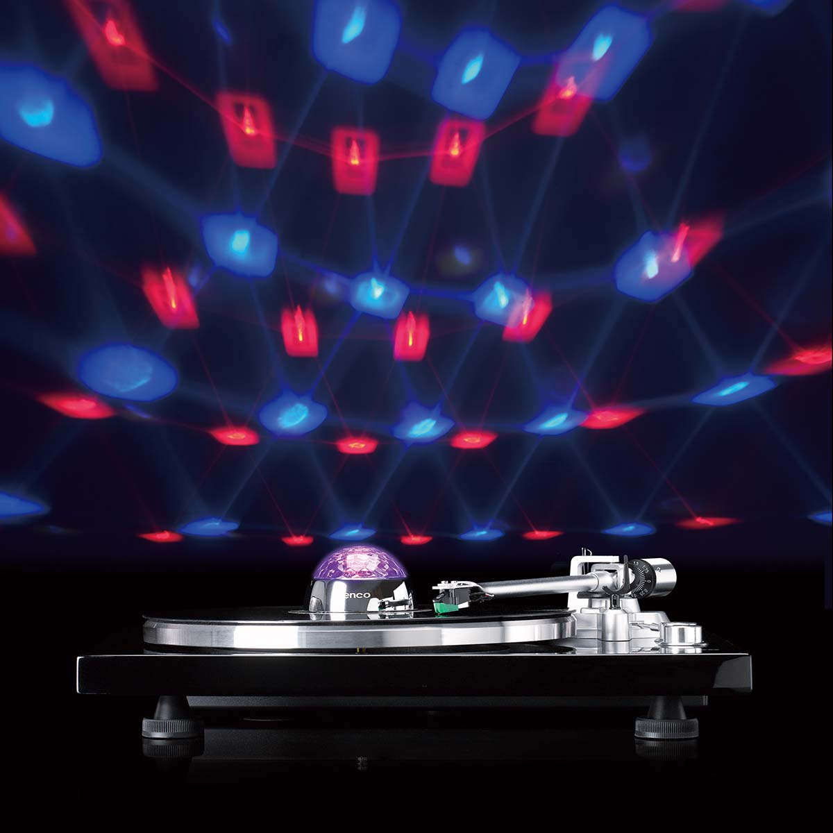 A turntable with a glowing purple sphere projects red and blue patterns onto the ceiling.