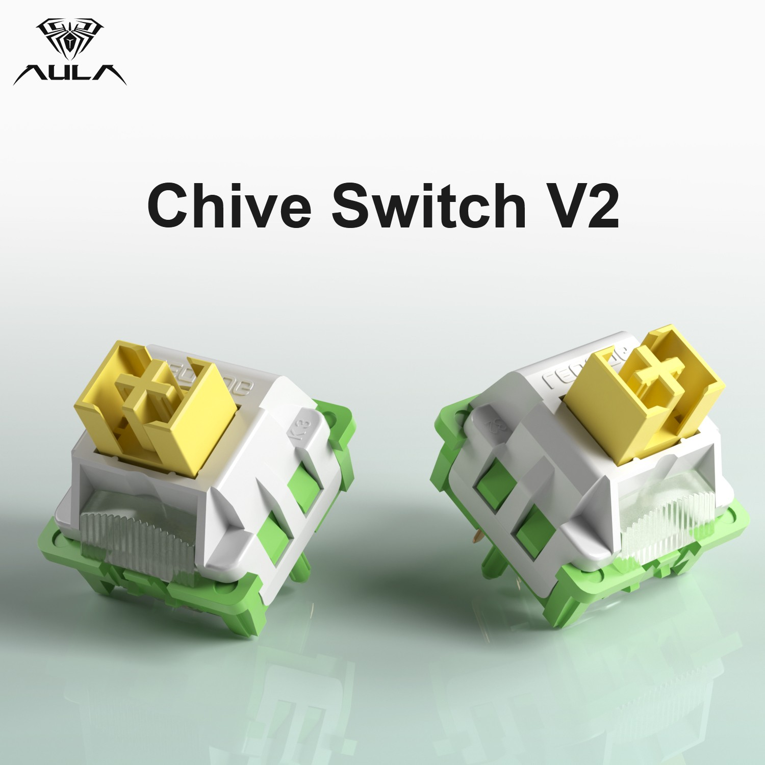 Chive Switch V2 metninin altında sarı saplı iki beyaz ve yeşil mekanik klavye anahtarı.