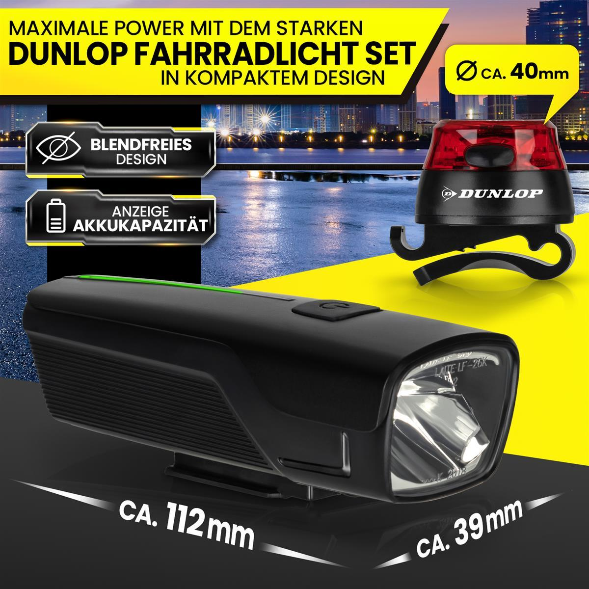 Dunlop Fahrradlicht Set mit Vorder- und Rücklicht, Akkuanzeige und Maßen vor nächtlicher Stadtkulisse.